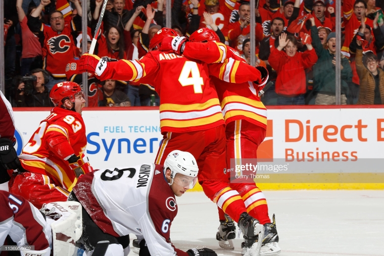 CALGARY, AB - APRIL 13: Rasmus Andersson #4, Sam Bennett #93 and teammates of the Calgary Flames celebrate a goal against the Colorado Avalanche in Game Two of the Western Conference First Round during the 2019 NHL Stanley Cup Playoffs on April 13, 2019 at the Scotiabank Saddledome in Calgary, Alberta, Canada. (Photo by Gerry Thomas/NHLI via Getty Images)